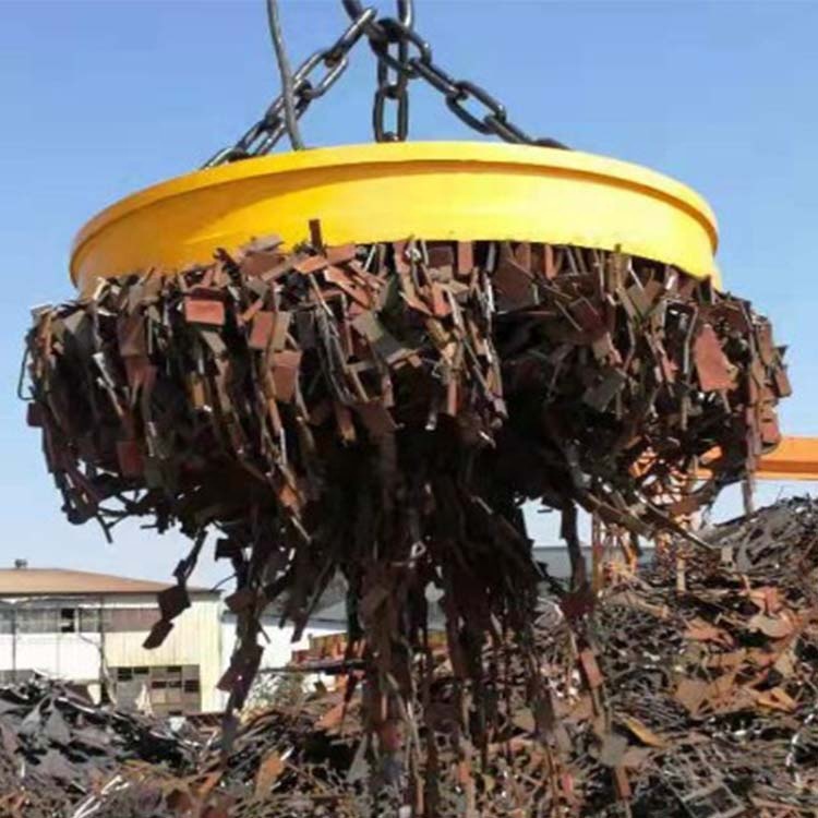Large scrap yard electromagnet lifting metal